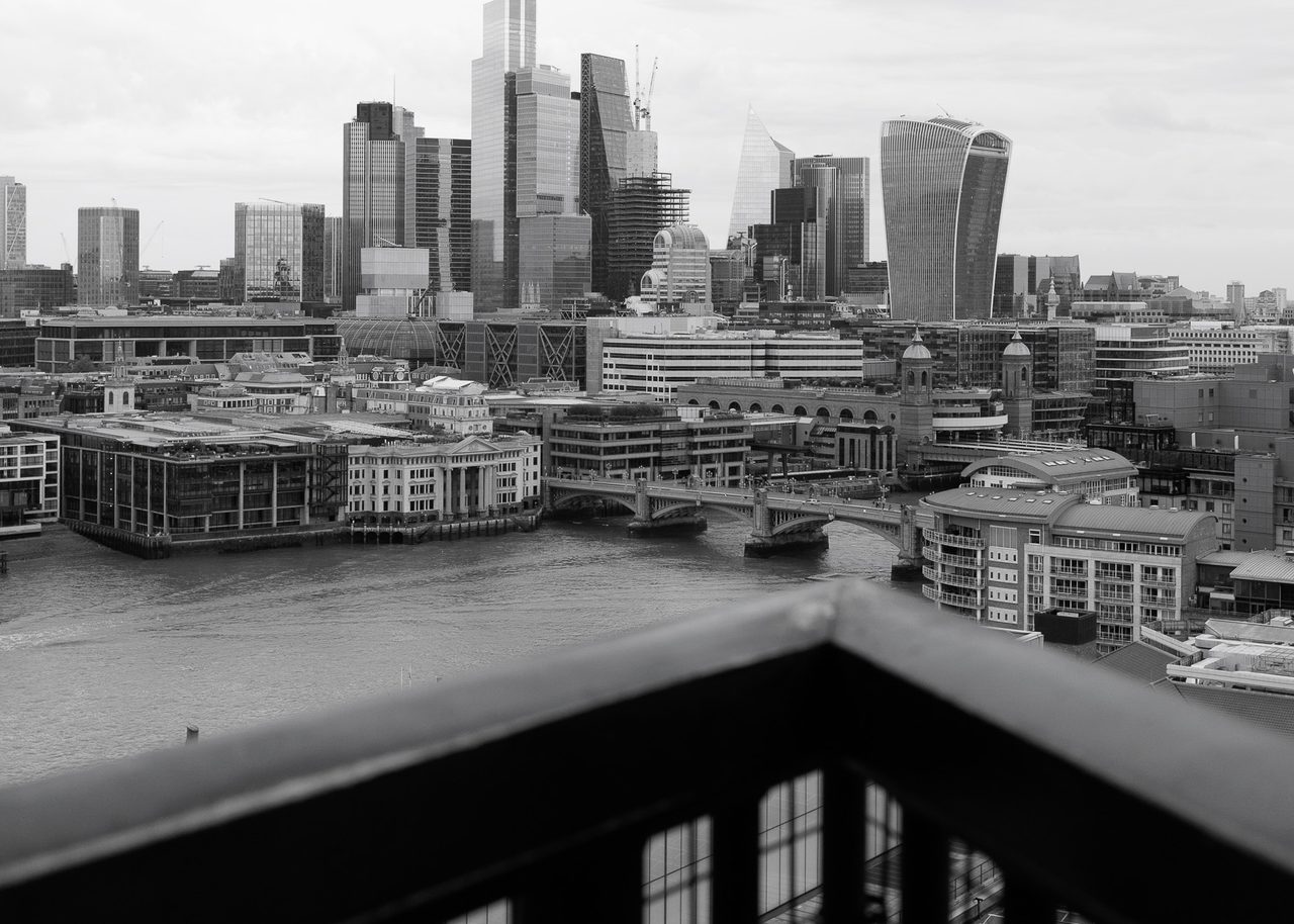 Skyline de la City de Londres visto desde la terraza del Tate Modern, con rascacielos, el río Támesis y un cielo nublado.